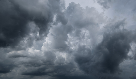 Dark storm clouds before rain used for climate background. Clouds become dark gray before raining. Abstract dramatic background.の写真素材