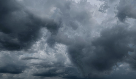 Dark storm clouds before rain used for climate background. Clouds become dark gray before raining. Abstract dramatic background.の写真素材