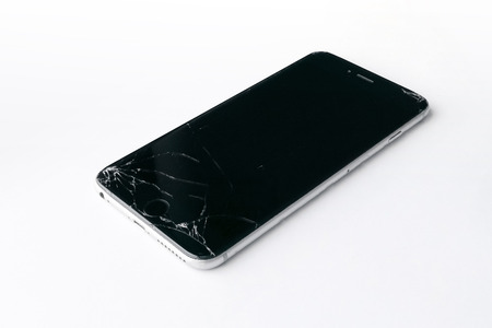 Mobile smartphone with broken screen isolated on white background.の写真素材
