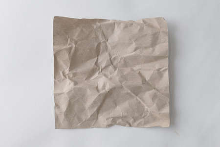 Brown wrinkle recycle paper background. Crumpled brown paper on white background, can use text banners products or business cards.の写真素材