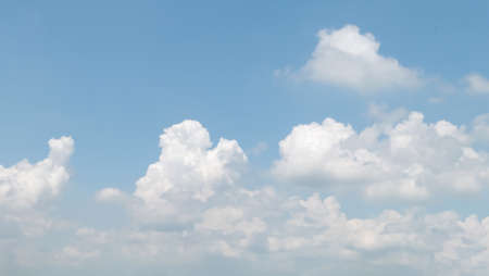 Blue sky with white soft clouds. Simple outdoor sky for background.の写真素材