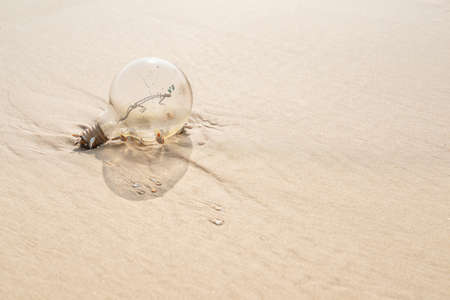 Old lamp With rust on a beach with yellow sand.の写真素材