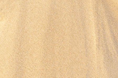 Sand pattern texture in tropical beach. Brown sand for background. Close-up.
