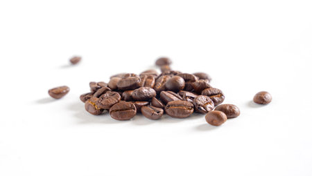 Coffee beans on white background. Pile of coffee beans. Close up.