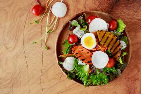Top view of fesh salad On wooden background.の写真素材