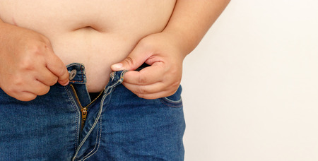 Woman trying to wear jeans.の写真素材