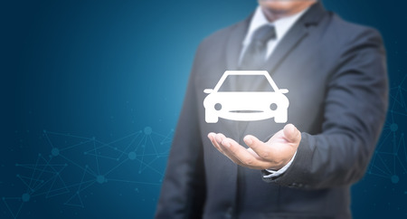 Business man holding car icon. Car insurance concept.の写真素材