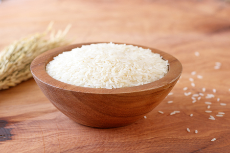 White rice in bowl on wooden background.の写真素材