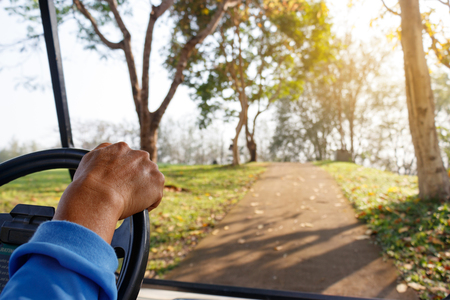 Golfer driving golf car.の写真素材