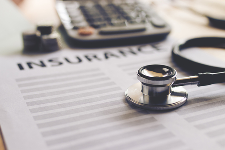 Health insurance form with money,passbook ,calculator and stethoscope concept for life planningの写真素材