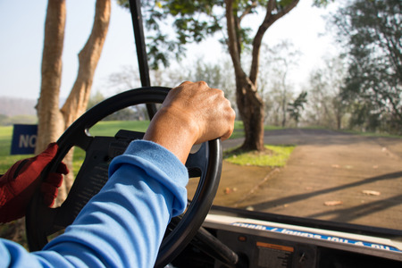 Golfer driving golf car.の写真素材