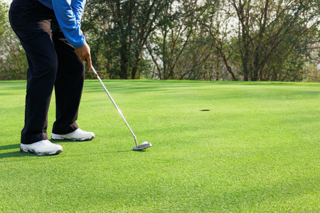 Man playing golf at a golf courseの写真素材