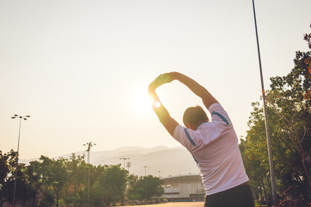 Young fitness sports man exercise with sunset background