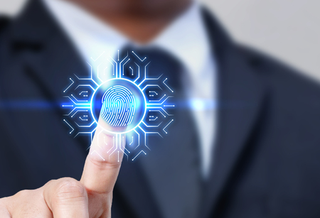 Businessman with fingerprint scanning technology. Security system concept.の写真素材