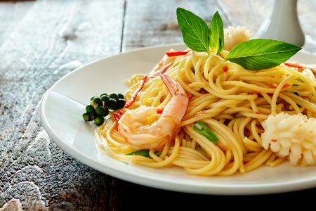 spicy spaghetti with seafood on plate.の写真素材
