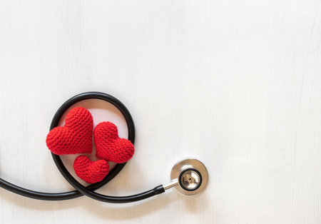 Stethoscope and heart on wooden background. Health care conceptの写真素材