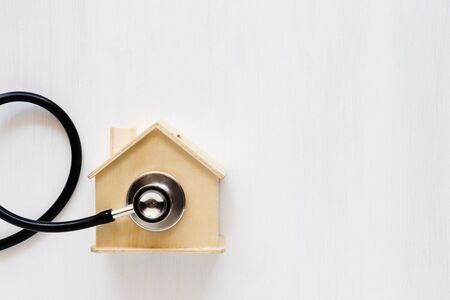 Home saving and stethoscope on white background. Home insurance concept.の写真素材