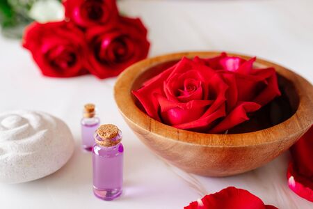 Spa bath product with rose oil and
Rose petals on a white background.の写真素材