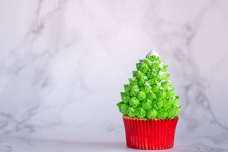 Christmas tree cupcake with powdered sugar. Homemade bakery.