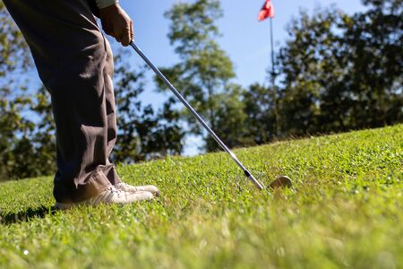 Man playing golf on a golf course.の写真素材