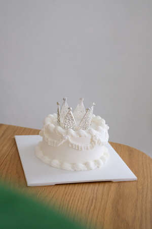 White happy birthday cake with crown.Homemade bakery concept.
