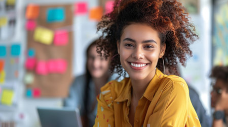 A cheerful young professional with a bright smile participates in a collaborative team planning session, surrounded by colorful sticky notesの素材