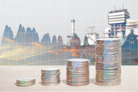 Double exposure of energy business and finance, Money coin stack with growing graph, Blurred power plant background.の写真素材