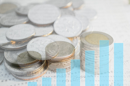 Double exposure of money coins stack with growing graph for finance and banking concept.の写真素材