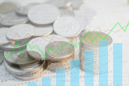 Double exposure of money coins stack with growing graph for finance and banking concept.の写真素材