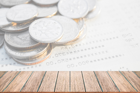 Double exposure of money coins for finance and banking concept, Empty wood table top, perspective wood can be used for display products.の写真素材