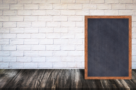 Chalkboard wood frame blackboard sign menu on wooden table, Laying on white wall background with copy space, Template mock up for adding your design and leave space beside frame for adding more text.の写真素材