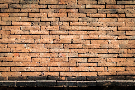 Background of old vintage brick wall with copy space, can be used for display or montage your products.の写真素材