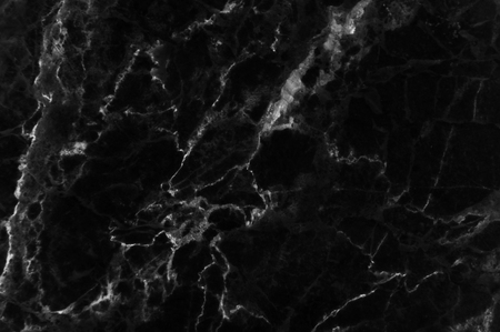 Black marble texture shot through with subtle white veining (Natural pattern for backdrop or background, Can also be used create surface effect to architectural slab, ceramic floor and wall tiles)の写真素材
