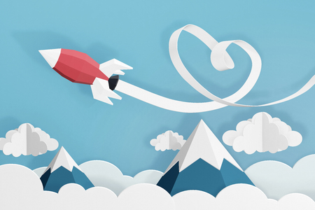 Paper art style of Heart ribbon with Rocket launch in the sky, Create custom greeting cards given on special occasions such as Happy new year or valentine day, 3D rendering design.の写真素材