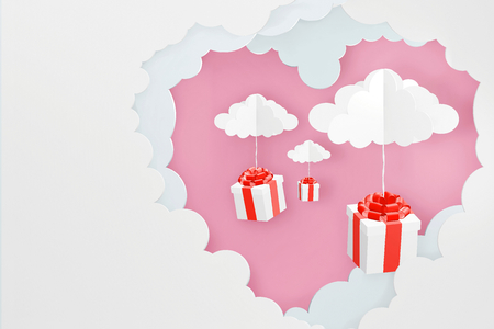 Paper art style of Heart shaped cloud and Gift box dropping from Pink sky background, Romantic, sweet, cute, Perfect Valentineâs Day Cards for the loved ones in your life, 3D rendering design.の写真素材