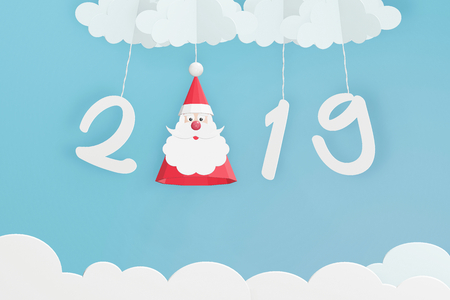 Paper art style of Santa Claus hat and 2019 hang with cloud in the blue sky, Perfect happy new year or Christmas cards for the loved ones in your life, 3D rendering design.の写真素材