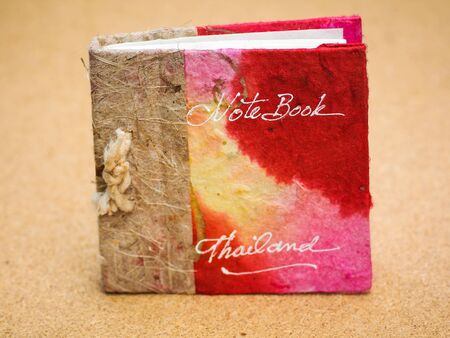 red book closed  on a table on   beige  background 