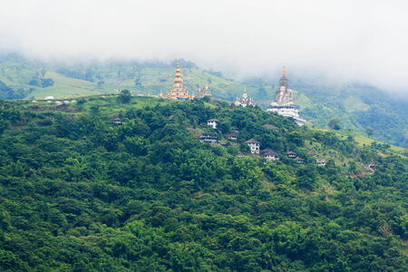 foggy and cloudy mountains in  village on the hillの写真素材
