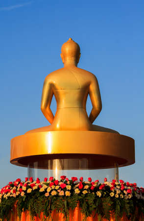 back of golden buddha statue on blue sky backgroundの写真素材
