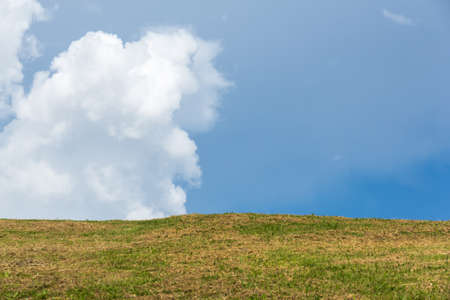 Green grass  with  blue sky background in Thailand.の写真素材