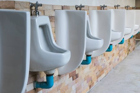 row of urinals in empty clean restroom