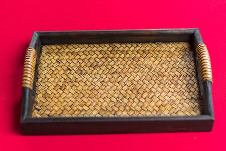 Empty wicker basket on red  backgroundの写真素材