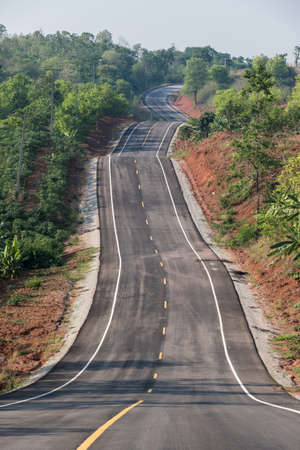 Empty country road  through the forest in Loei Province Thailand