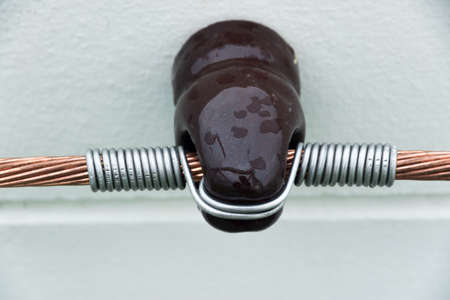 power cable in  insulators  on the wall