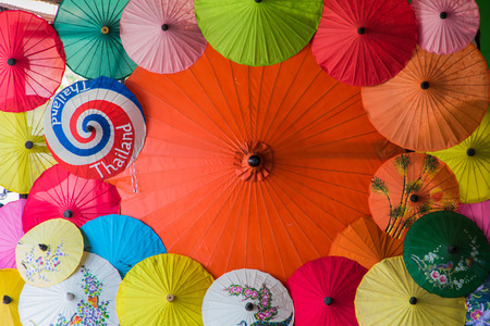 one big umbrellas among many small umbrellas color set.の写真素材