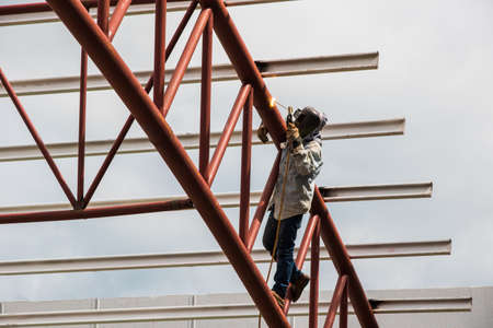 Workers are welding structures of construction siteの写真素材