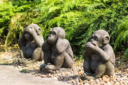 Monkey statues sit,Close it eyes, mouth, ears. focus on middle monkeyの写真素材