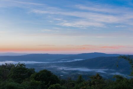 Beautiful foggy sunrise landscape. view point on hills countryside in Loei, Thailand.の写真素材