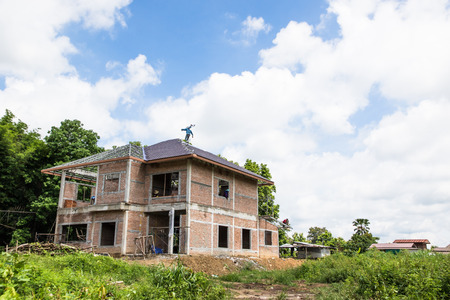 Building & Construction and roof in progress to new house on blue sky background in Thailandの写真素材
