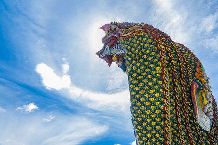 Naka statues and Sun corona on blue sky  with clouds in nature.の写真素材